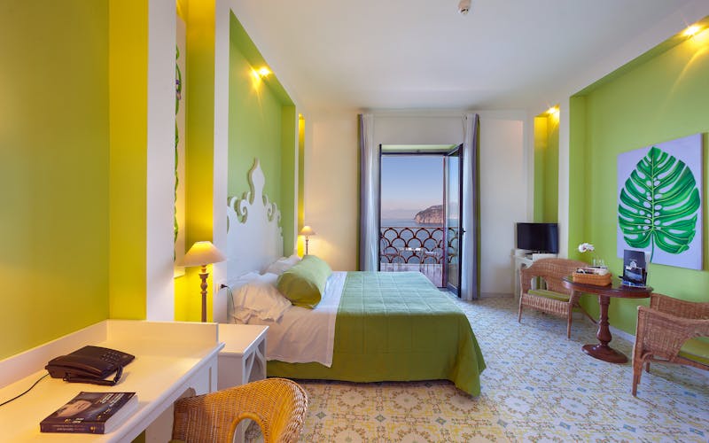 Hotelzimmer in frischen grünen Farbtönen mit Balkon
